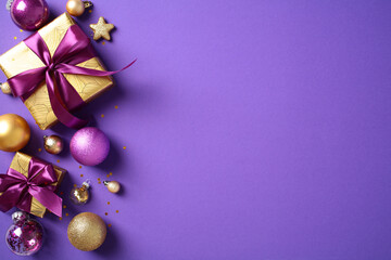 Merry Christmas greeting card design. Top view golden pattern gift boxes decorated purple ribbons, baubles, confetti on purple background. Flat lay.