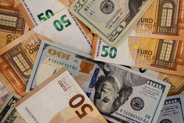 Close-up of various denominations of Euro and US Dollar banknotes. Currency exchange and international finance concept 