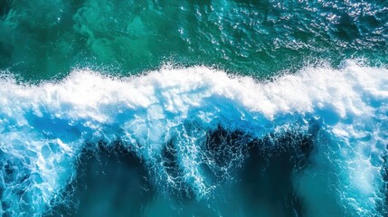 This image captures the dynamic and powerful waves of the ocean, emphasizing the vibrant water hues and the ceaseless energy of the waves in motion.