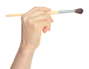 Woman hand holds paint brush, isolated on transparent background, painting and design concept