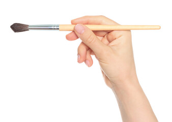 Woman hand holds paint brush, isolated on transparent background, painting and design concept
