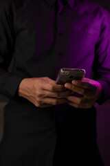 Happy young businessman using smart phone in office or home.
