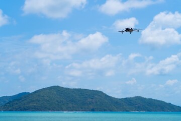 Modern drone in blue sky. Flying a quadrocopter helicopter drone in the air, in a clear blue sky. 