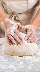 Hands gently kneading dough on a floured surface. Perfect for baking tutorials or cookbooks.