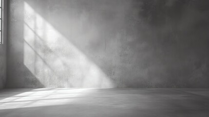 A serene interior scene showcasing a minimalistic gray concrete room illuminated by soft sunlight through a window.