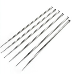 Six metallic knitting needles arranged in a row, used for knitting and crafting.