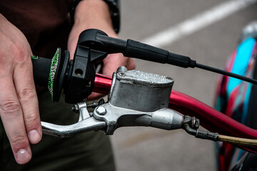 Hand holding the throttle on a motorcycle handlebar