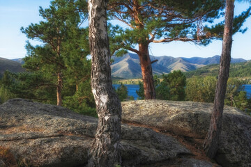 Fototapeta premium Nature of eastern Kazakhstan, layered rocks near Lake Shybyndykol with blue water