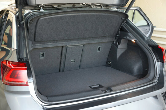 Grey soft car boot liner mat in trunk of auto