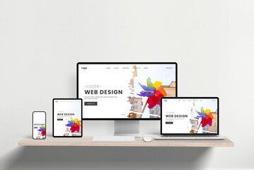 Responsive web design studio page displayed across laptop, phone, tablet, and computer on office...