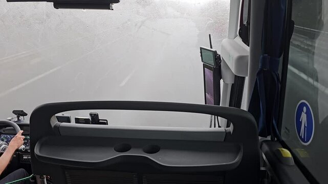 A bus driver driving in highway in a raining day bad weather
