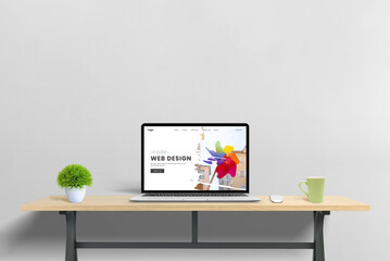 Laptop computer showcasing a web design studio page presentation, representing the concept of modern web development