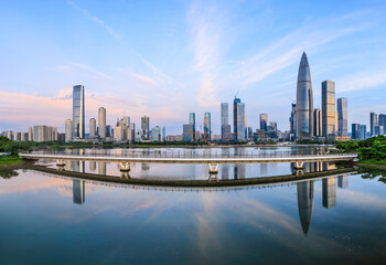 Fototapeta premium Shenzhen skyline and modern commercial buildings scenery at sunrise. Famous city landmark by the lake in China.