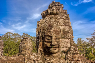 Fototapeta premium Sculpted faces on the bayon temple in angkor thom- angkor wat archaeological park, siem reap, cambodia.