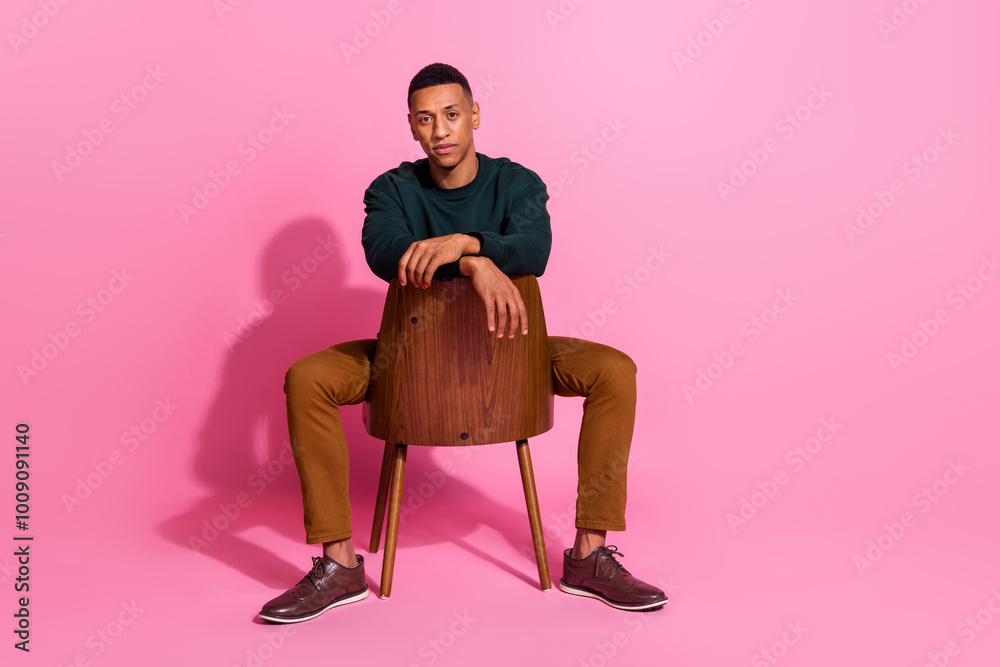 Canvas Prints Full length photo of serious cool guy dressed pullover sitting armchair emtpy space isolated pink color background