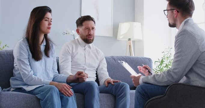 Family couple consulting with a psychologist during a therapy session. They receive support, help, and advice, engaging in a conversation for improving relationship and addressing any issues.