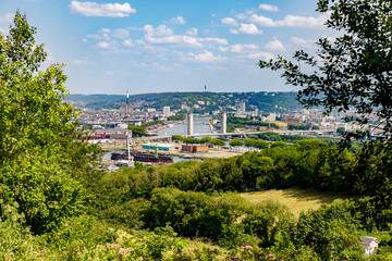 Naklejka premium CANTELEU, NORMANDY, FRANCE: aerial view of Rouen, shipyards, former wine storehouse, Flaubert bridge, quays of Seine river, cathedral, Sainte Catherine hill, Mesnil-Esnard radio tower