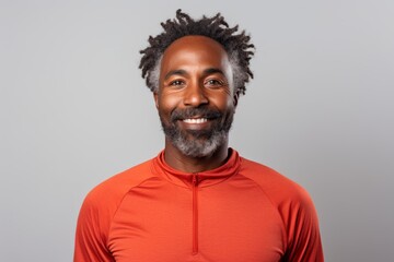Obraz premium Portrait of a tender afro-american man in his 40s wearing a moisture-wicking running shirt while standing against white background