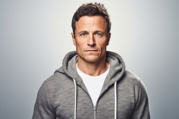 Obraz premium Portrait of a content man in his 40s wearing a zip-up fleece hoodie on white background