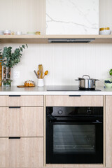 Modern kitchen with oven and induction stove on countertop