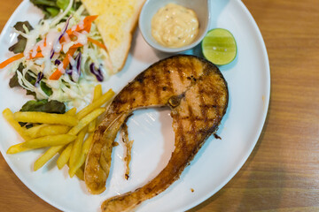 Grilled salmon steak fillet with french fries