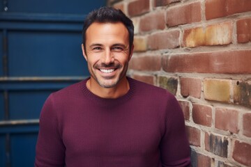Obraz premium Portrait of a cheerful man in his 40s wearing a thermal fleece pullover on vintage brick wall