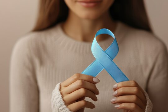 A woman holds a blue awareness ribbon, symbolizing support for various causes, showcasing unity and hope