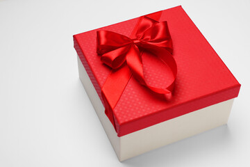 Gift box with bow on light grey background