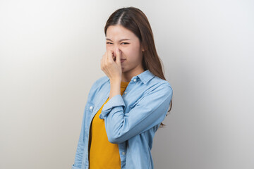Portrait of pretty brunette hair, disgust smell bad strong asian young woman, girl hand squeezing,...