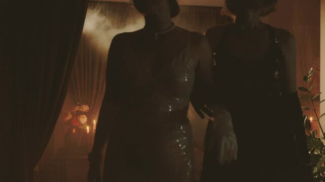 Shadow silhouette of couple two women in dark room, night club full smoke. Woman in black white shiny dress, evening gown. Sexy girls leaving the party new year old retro style 20s. video 4k