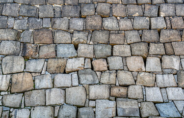 Traditional japanese stone wall moat at the base of Osaka Castle. Texture background.