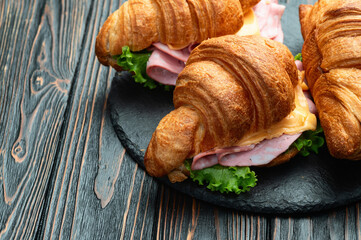 Croissant sandwich with salad ham and cheese . Top view