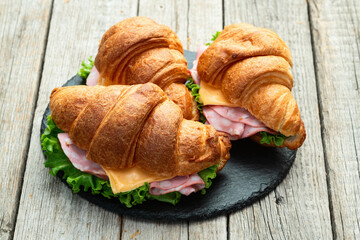 Croissant sandwich with salad ham and cheese . Top view
