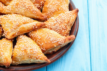 Homemade triangle puff pastry with meat on rustic background . Samosa
