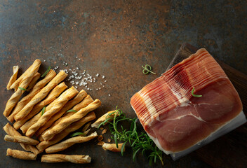 Prosciutto with bread sticks and rosemary.