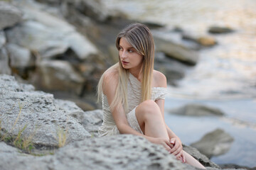 Yong woman sitting on the rocks