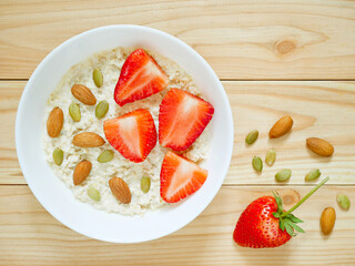 Oat porridge with almonds, pumpkin seeds and fresh strawberries