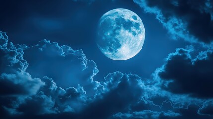 The moon glowing behind the moving clouds