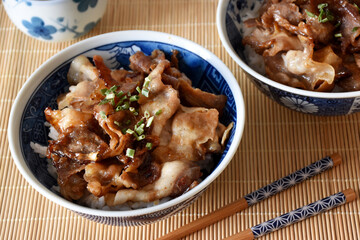 Butadon is a Japanese dish featuring sliced pork simmered in a savory-sweet sauce of soy sauce, sugar, and mirin, served over a bowl of steamed rice. It’s a comforting and flavorful meal.