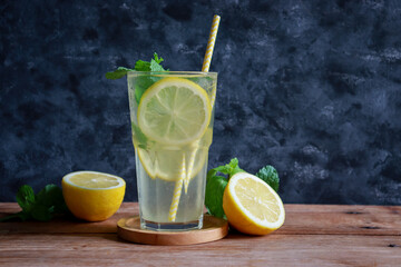 Glass of lemonade with fresh lemon sliced and mint leaf for summer drink.