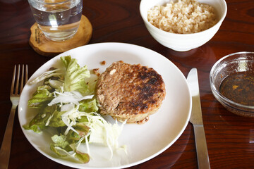 Japanese hambagu is a hamburger steak made from ground beef or pork, mixed with onions and breadcrumbs, then pan-fried. It's served with a rich sauce, typically alongside rice or vegetables.