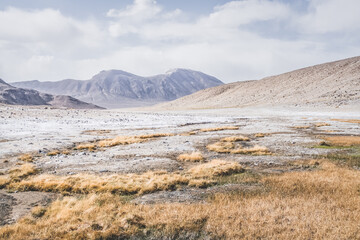 Panoramic landscape of textured Tien Shan mountains in Pamir in Tajikistan, panoramic landscape of a mountain range with snow and glaciers in summer