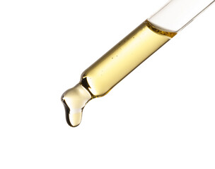 Essential oil dripping from pipette against white background