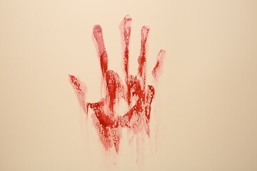 Bloody hand print of human on beige background
