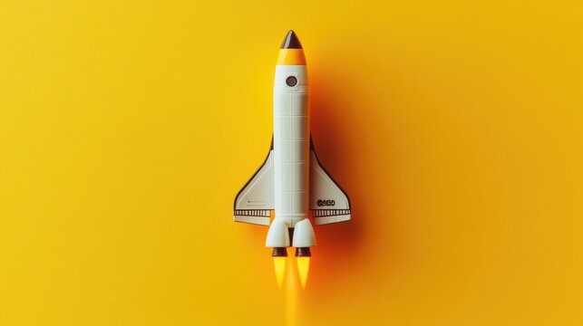 A scale model of a space shuttle on a bright yellow background - Powered by Adobe