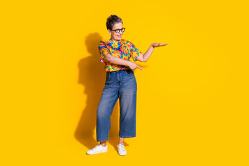 Photo of lovely charming nice woman wear trendy clothes look empty space isolated on yellow color background