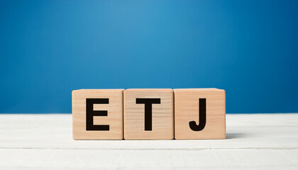 Wooden cubes with abbreviation ETJ. Extraterritorial Jurisdiction. English Teaching Jobs. Close-up.