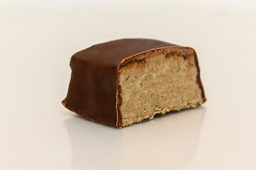 Halva in chocolate on a white background. Sweet oriental dessert.