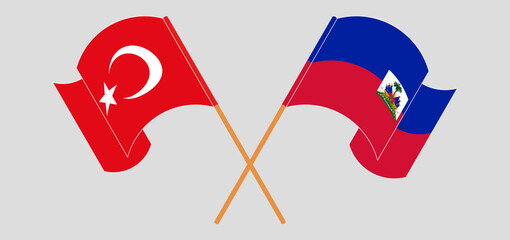 Crossed and waving flags of Turkiye and Republic of Haiti. Vector illustration