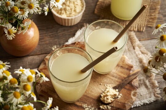 Fresh natural whey in a glass - protein rich healthy nutritional supplement , with bamboo straws